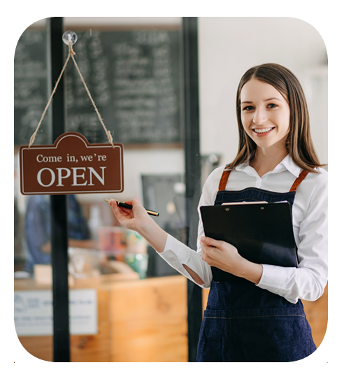 successful business owner in front of her business with an open sign